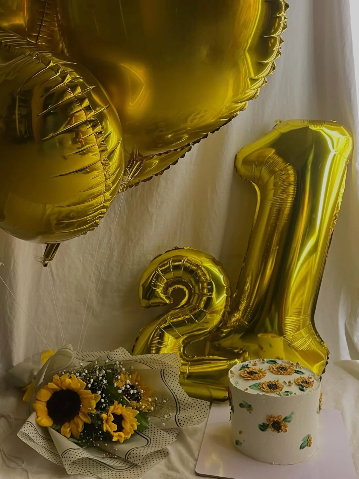 21st birthday sunflower cake styled with gold number balloons