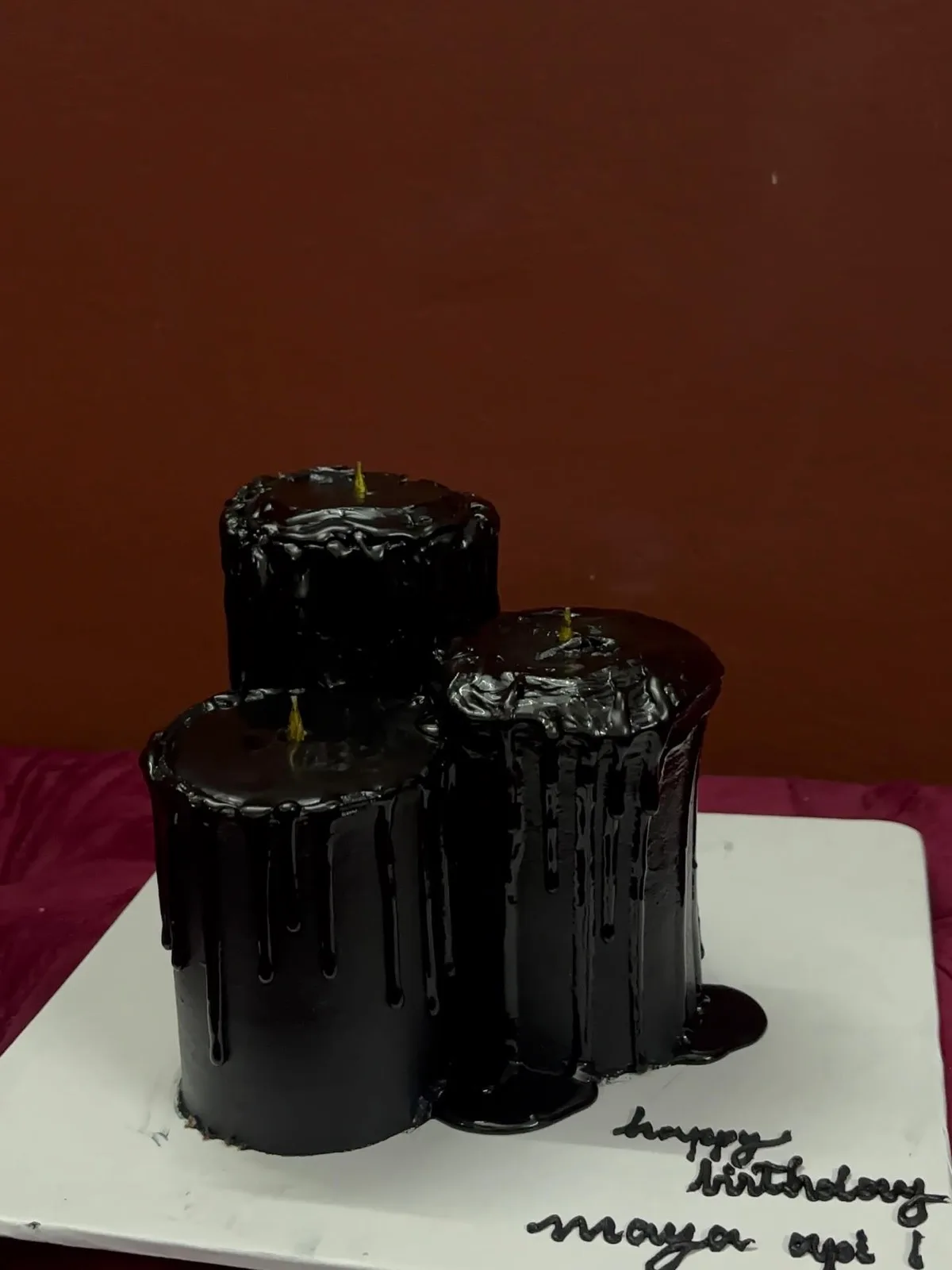 Three-cake black drip tower for a birthday