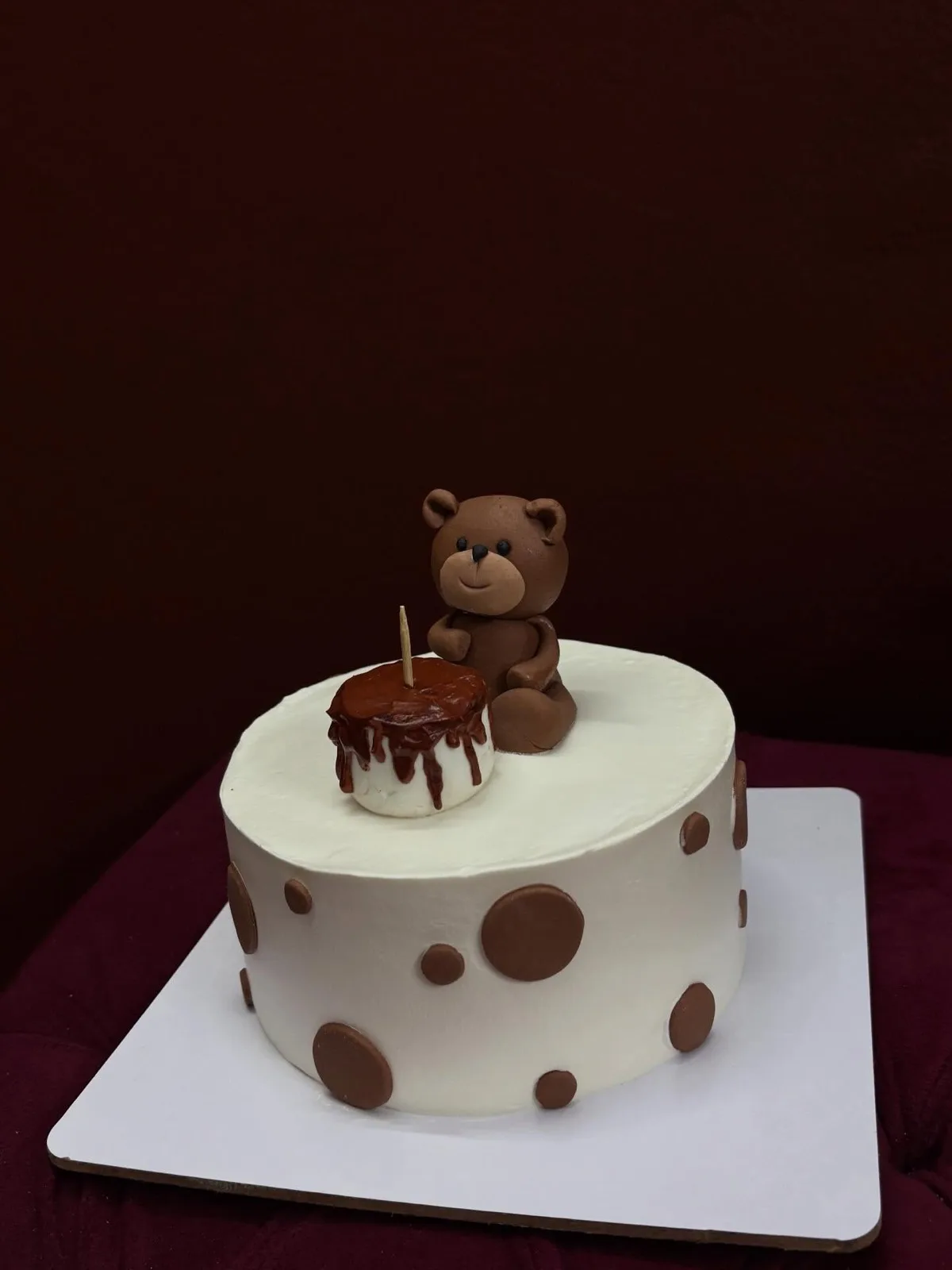 Chocolate polka dot cake with a fondant teddy bear topper