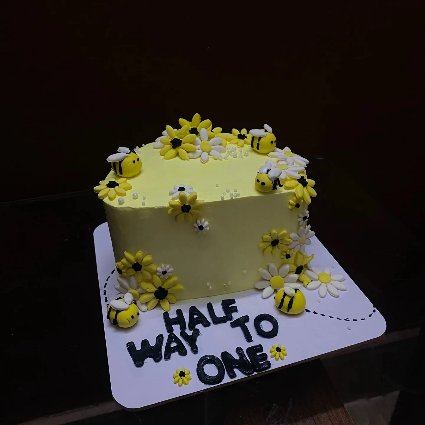 Bee and daisy half-birthday cake with a Half Way To One topper