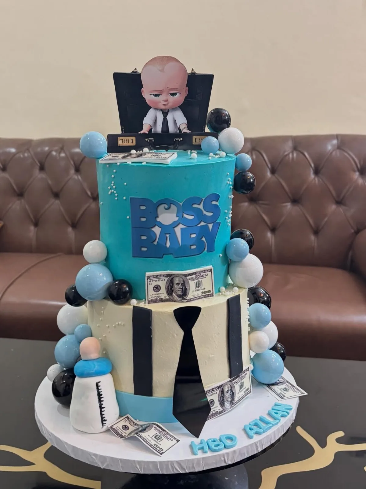 Two-tier Boss Baby themed cake with balloons and fondant details
