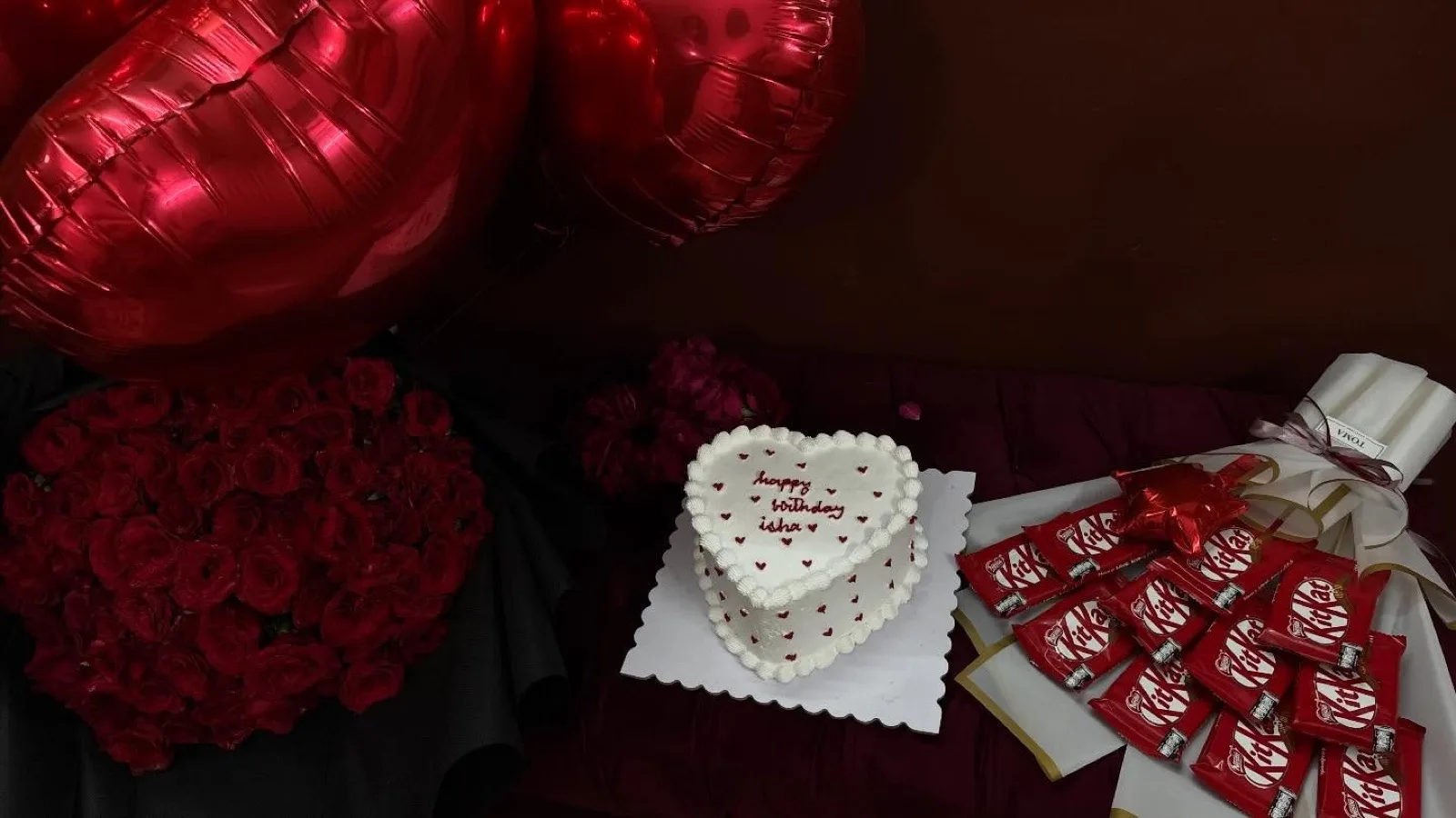 Heart cake with matching chocolates and a red rose bouquet