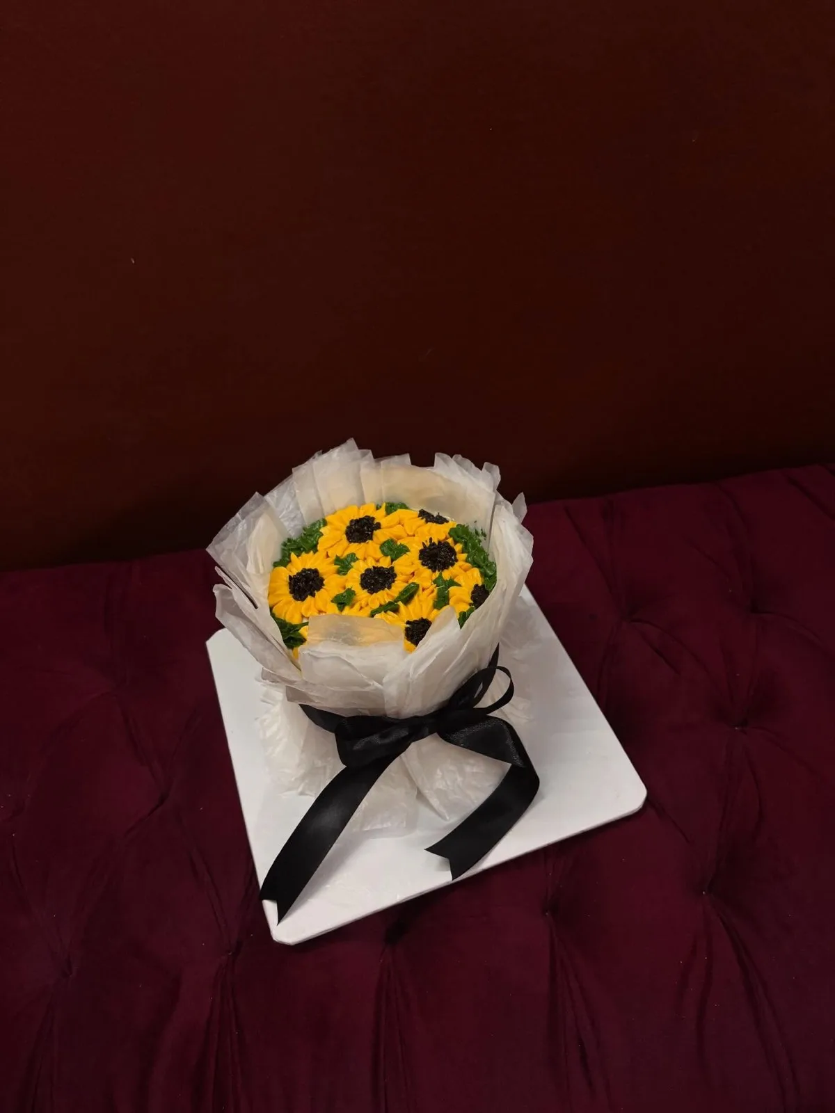 Cake designed as a wrapped sunflower bouquet